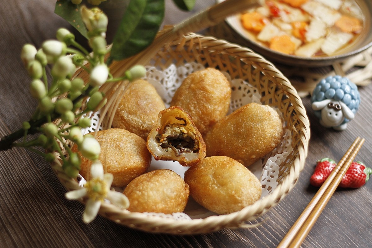 Banh ran can be stuffed with minced pork, glass noodles, and mushrooms, and served with a tangy dipping sauce
